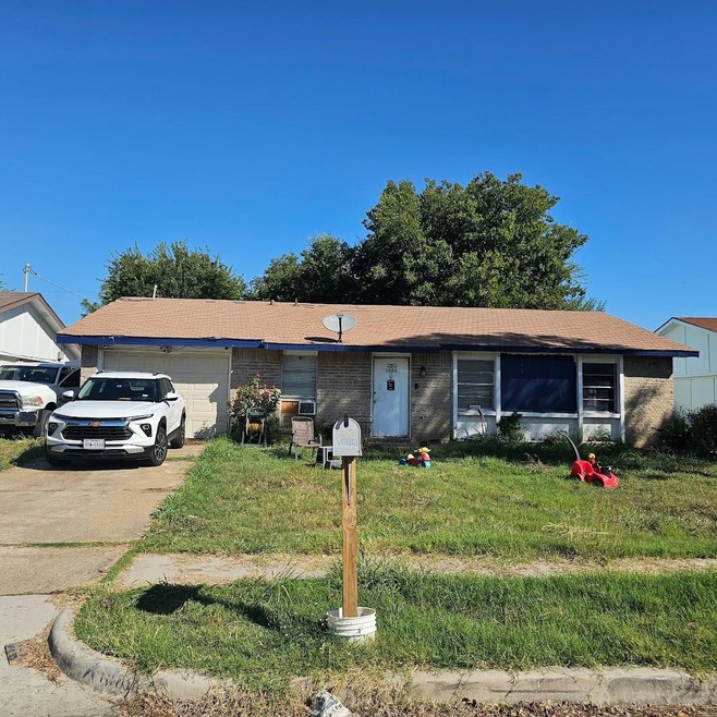 Single story home with a front lawn and a garage