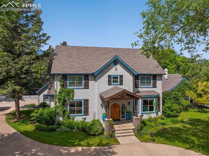 View of front of home with stucco siding and a shingled roof