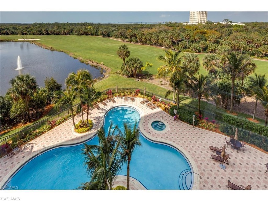 Pool featuring a water view, fence, a yard, a comm
