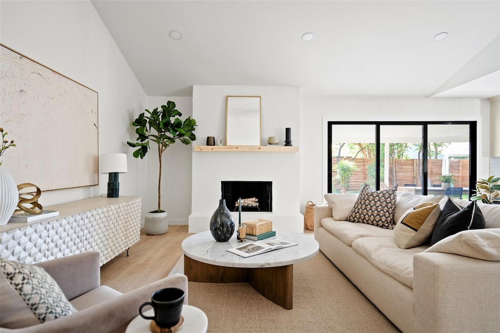 Living room featuring a fireplace with raised hea
