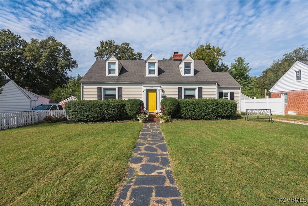 Cape cod house featuring a chimney