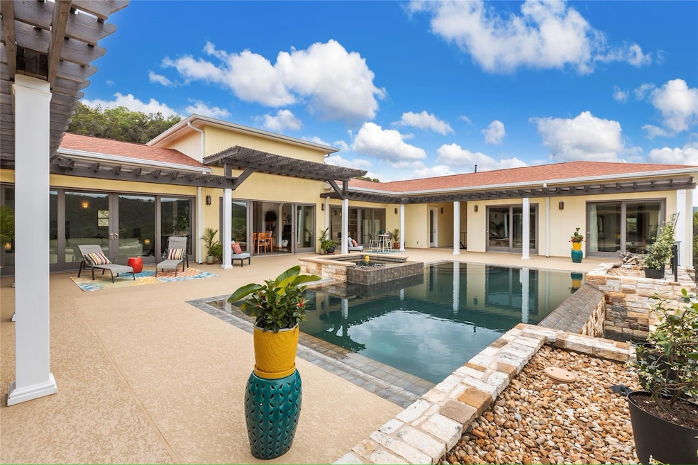 View of swimming pool with a patio and a pool wit