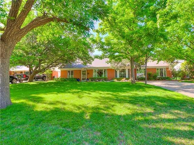 Exterior Front. Beautiful full trees grace the fro