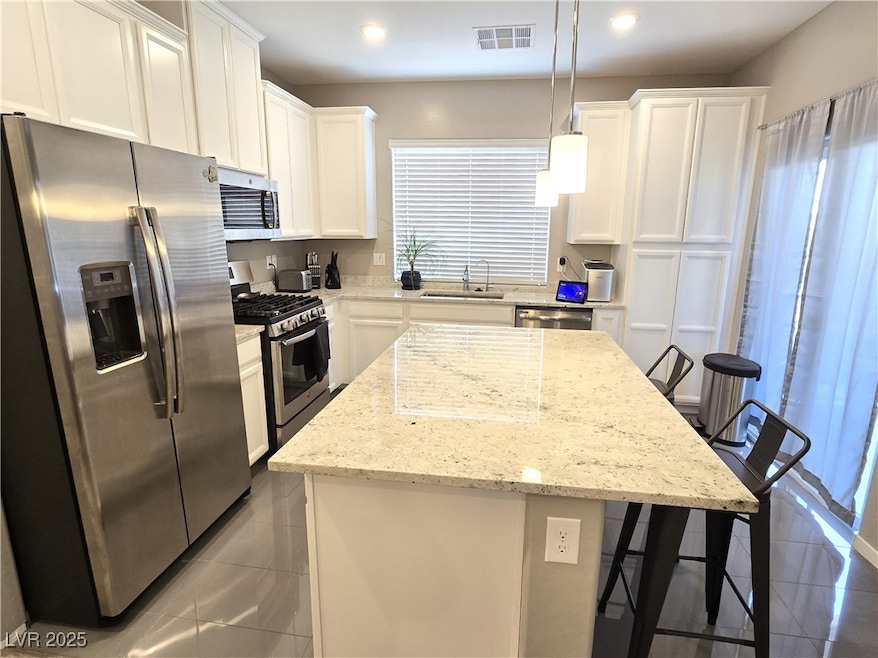 Kitchen with stainless steel appliances, white cab