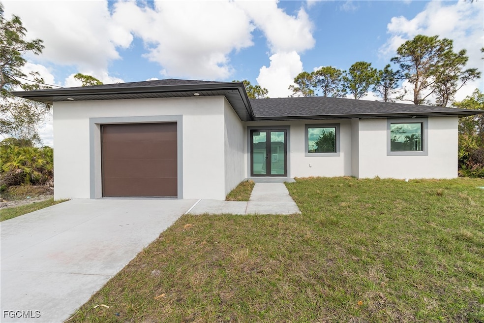 View of front facade featuring a front lawn, stucco siding, a garage, concrete driveway, and a shingled roof