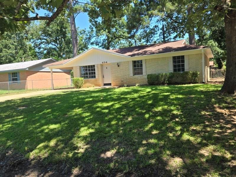 Brick home with new exterior paint and shaded fron