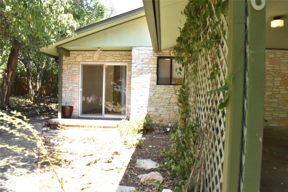 Property entrance featuring stone siding