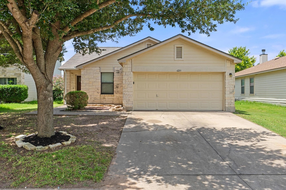 View of front of house featuring driveway, stone 