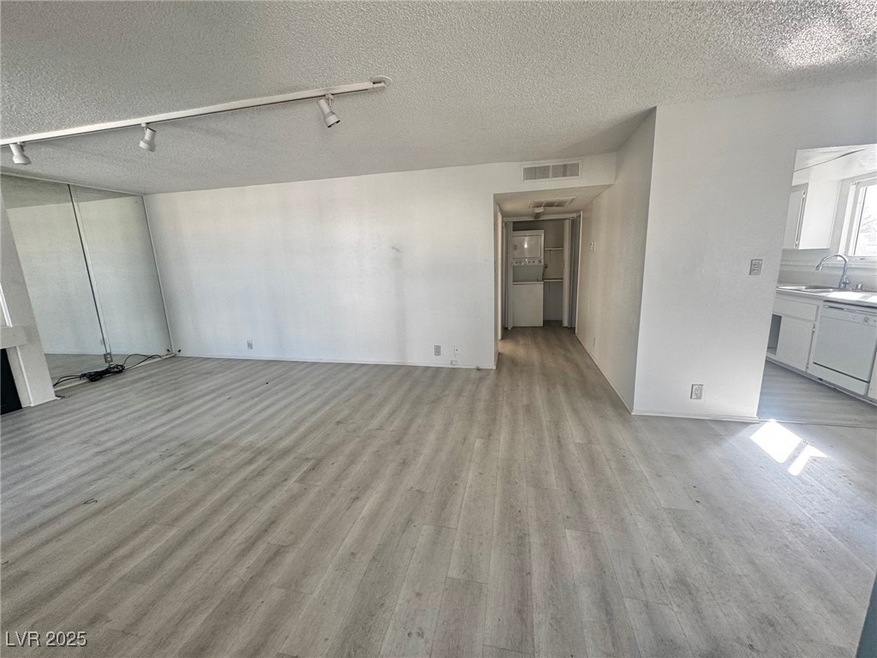 Unfurnished living room with light wood-style floo