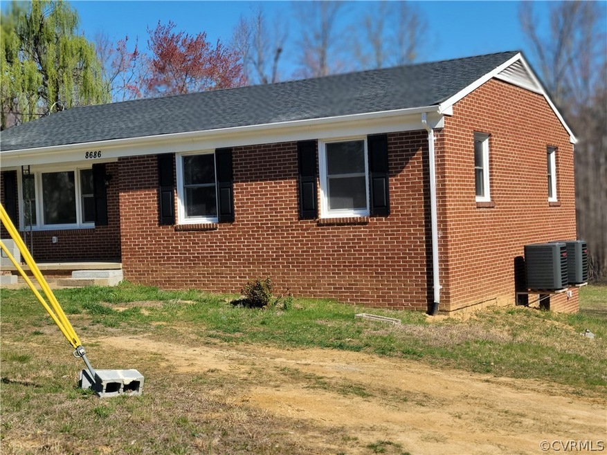 View of front of home with central AC
