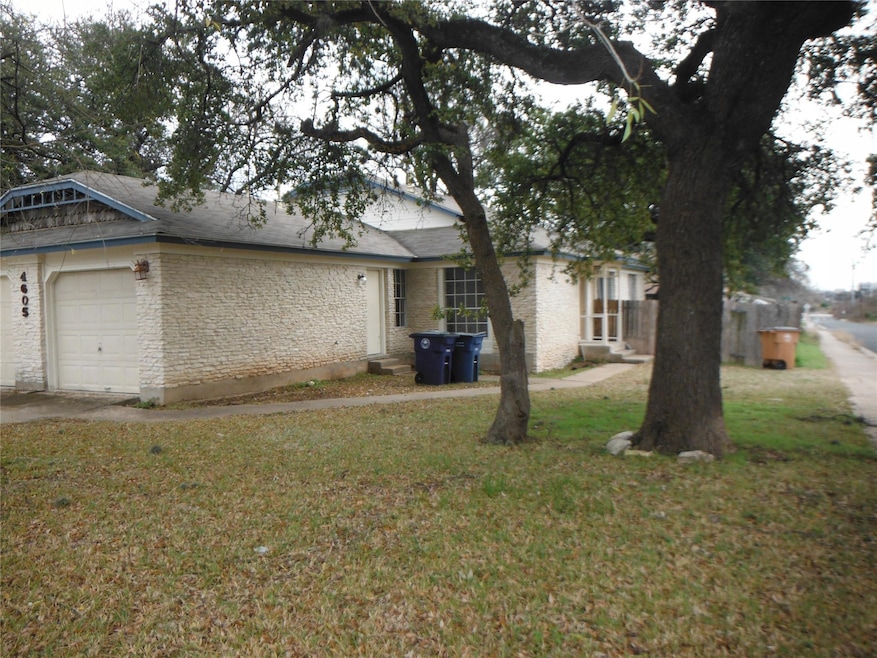 View of front of home with a garage, a front yard