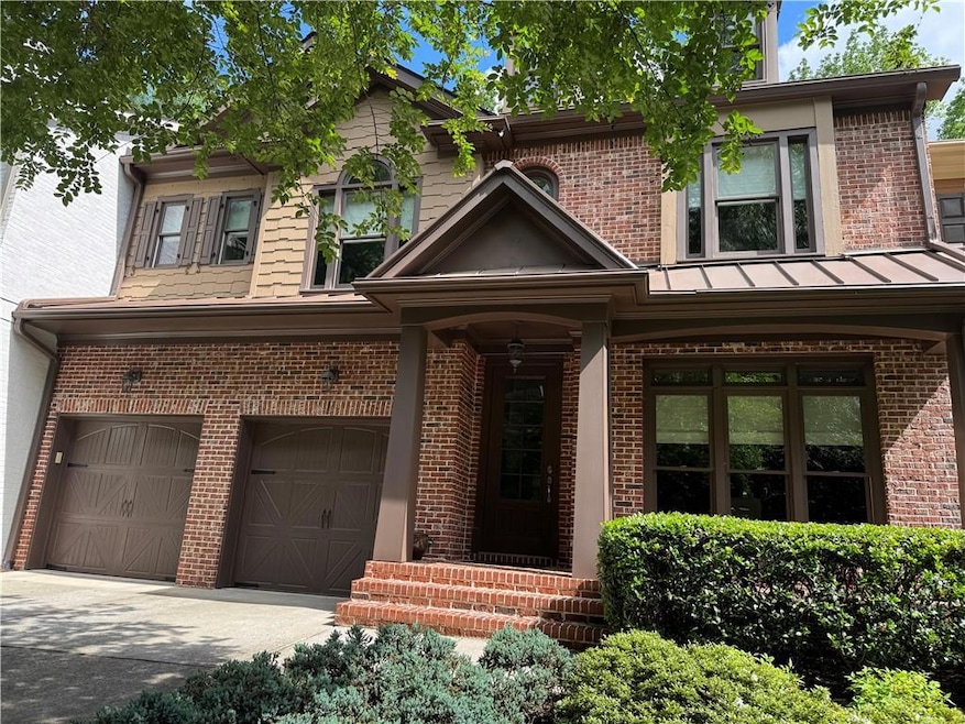 View of front facade with an attached garage, bric