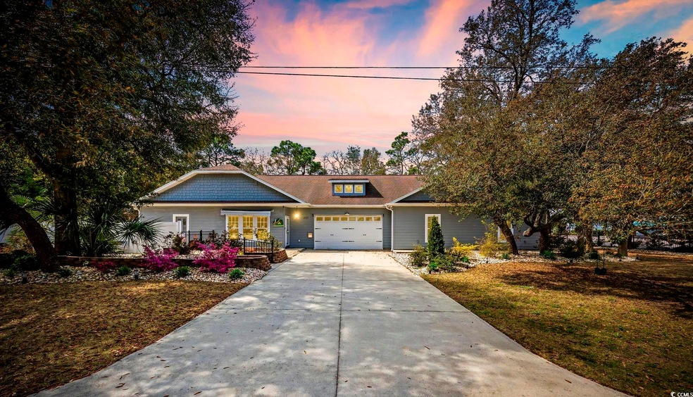 View of front facade featuring driveway, a garage,