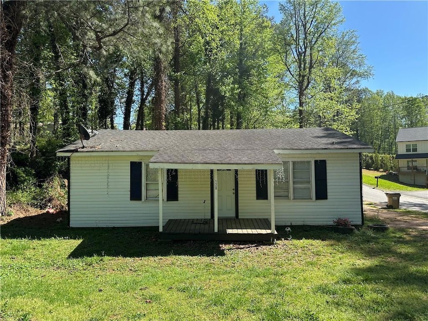 View of front of house featuring a front lawn, cov
