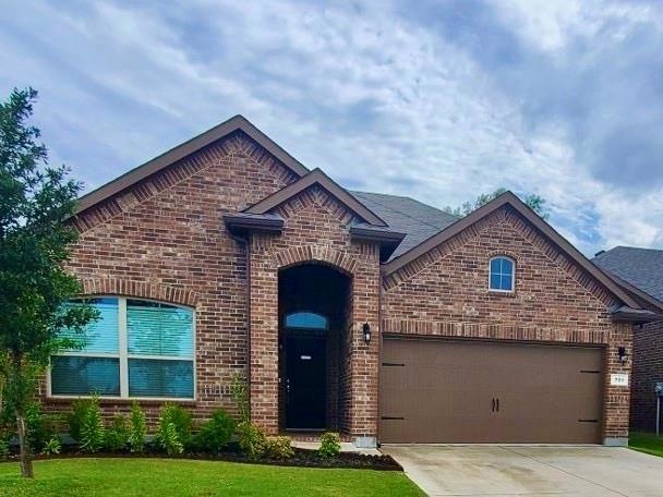 View of front property with a garage and a front yard
