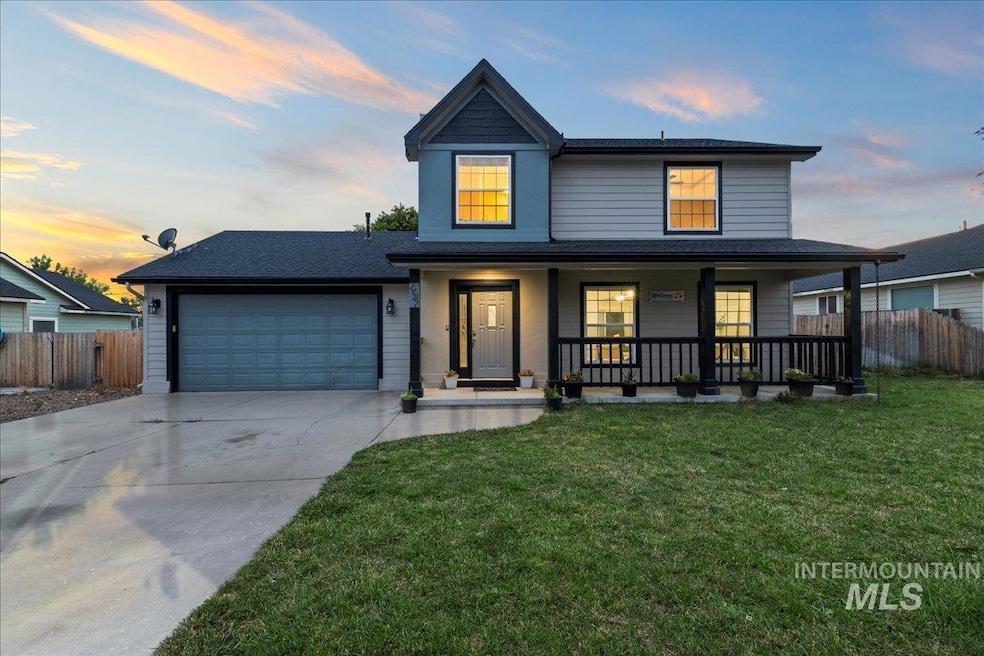 View of front of property featuring driveway, a garage, a porch, and roof with shingles