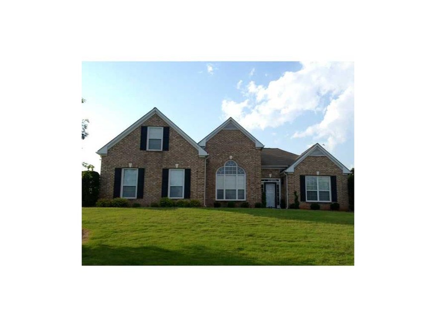 Exterior Front. Main View, Fresh Low Maintenance Dwarf Landscaping, accent lighting. Flowering Plant Beds. Seasonal Color