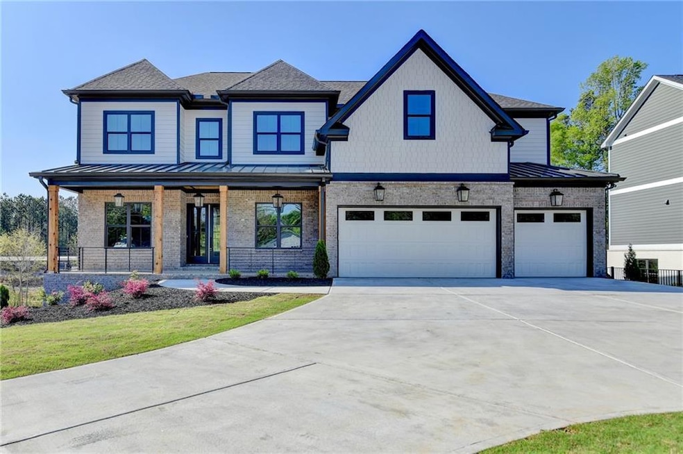 View of front of home with concrete driveway, an a