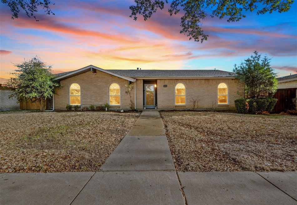 Single story home with fence and brick siding