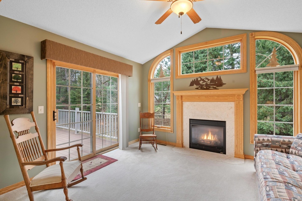 Welcome to 15442 Tungsten Way NW, Ramsey, MN 55303! The main level sunroom features a wall of windows, gas fireplace & walks out to the back yard deck.