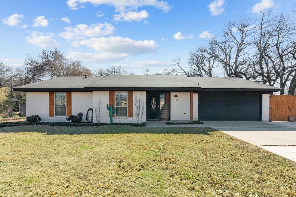 Ranch-style house with a garage and a front yard