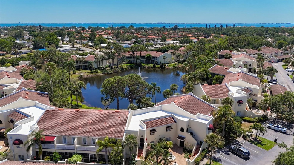 Aerial of pond and fountain view that is enjoyed off the screened and glass enclosed Florida room.
