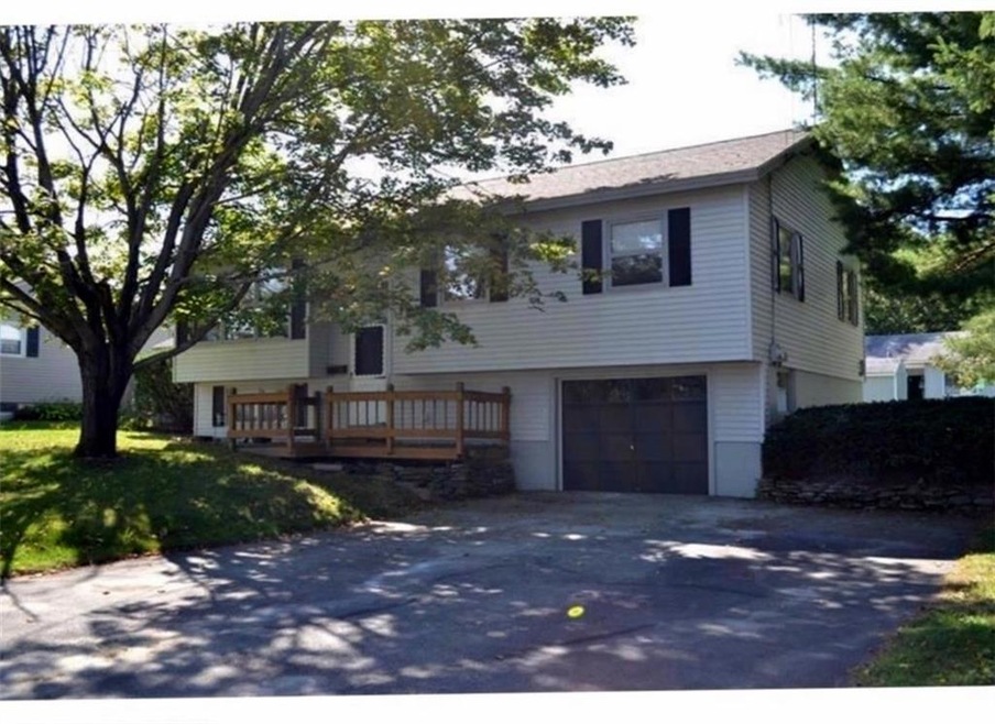 Front of home, garage and paved driveway