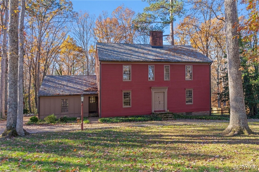 Colonial inspired home featuring a front lawn