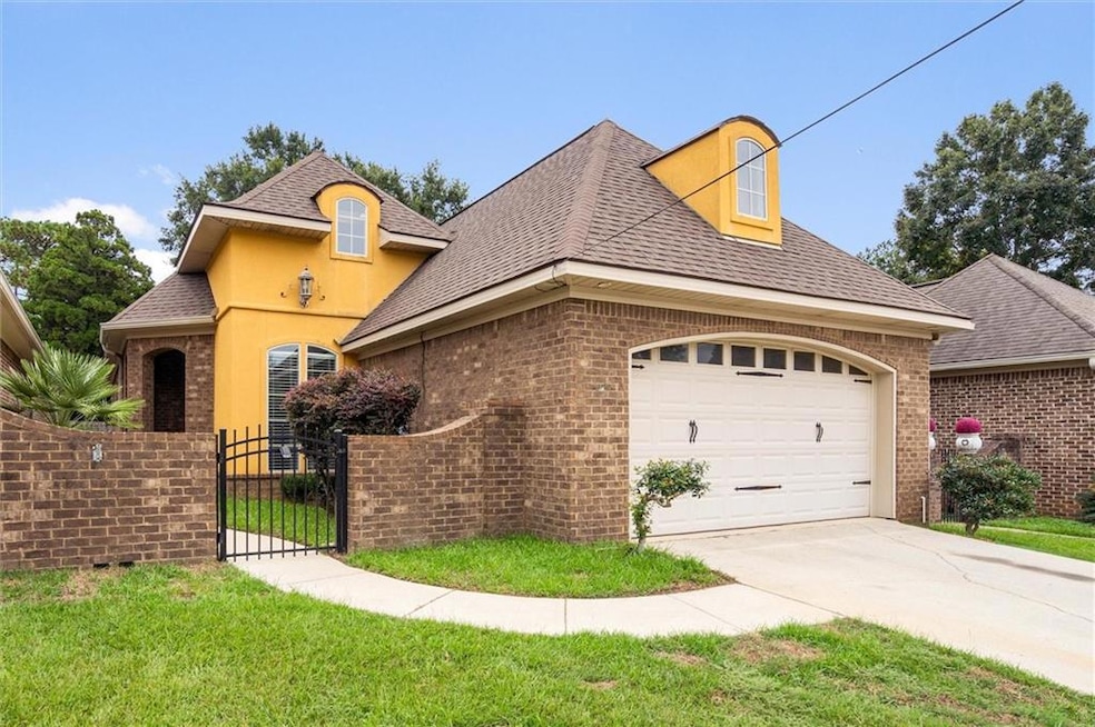 French country home with brick siding, driveway, a
