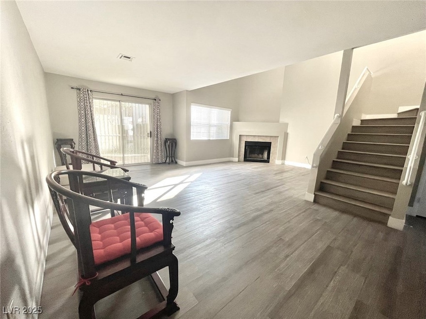 Living area with stairs, wood finished floors, vis