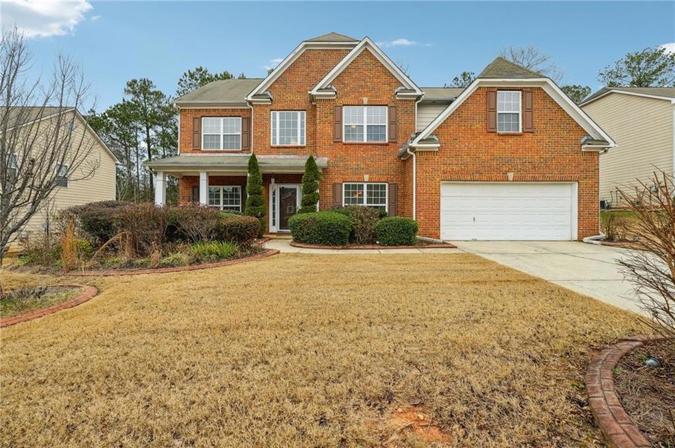 View of front of home with a garage and a front la
