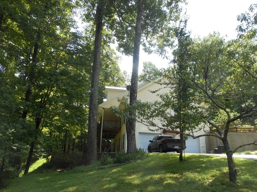 SIDE  OF HOME.  FRONT PORCH OVERLOOKS POND