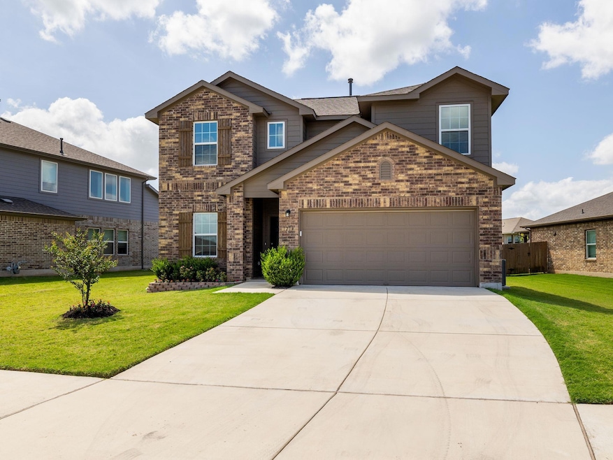 Traditional home featuring brick siding, driveway