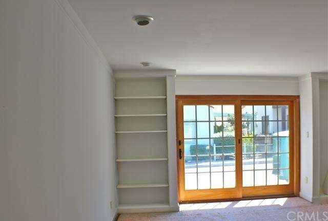 Bright Living Room with Sliding Door to Brick Porc