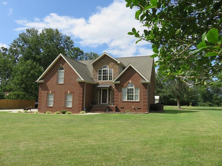 Front of this custom built brick and stone 3 BR, 2.5 BA home with beautiful inground pool