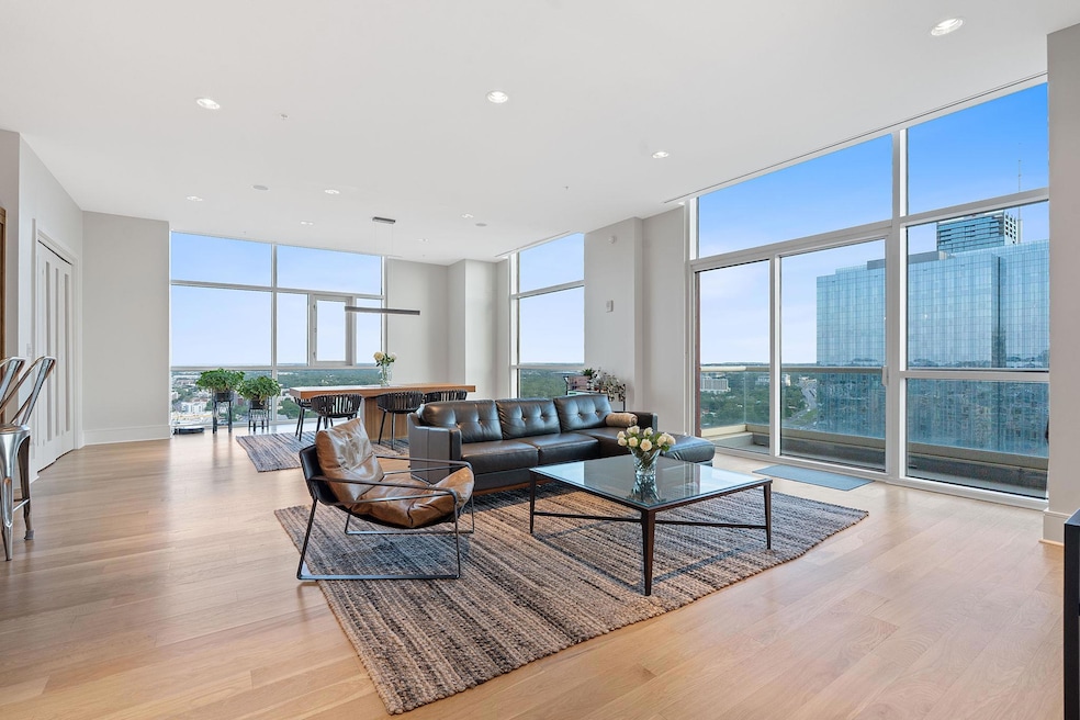 Living room featuring a wall of windows, light wo