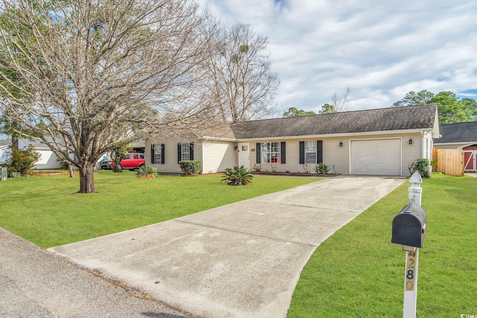 Single story home with concrete driveway, an attached garage, and a shingled roof