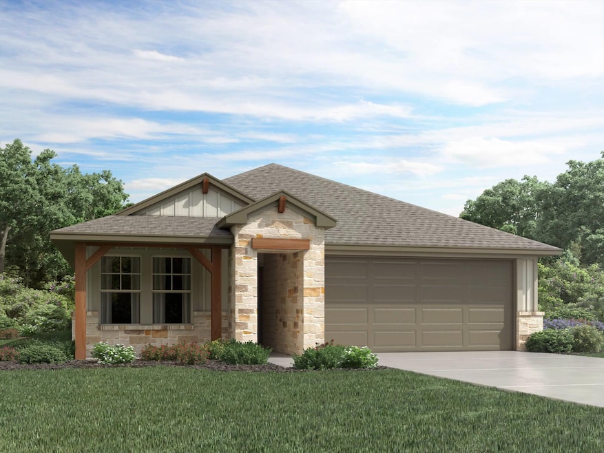 View of front of home with stone siding, a shingl