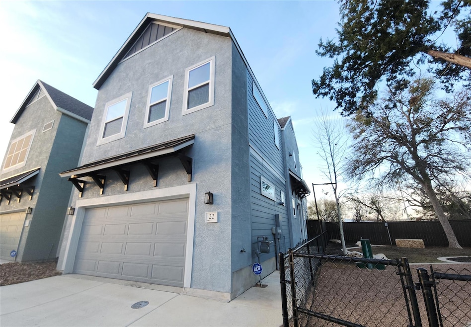 View of front of house with a garage, stucco sidi