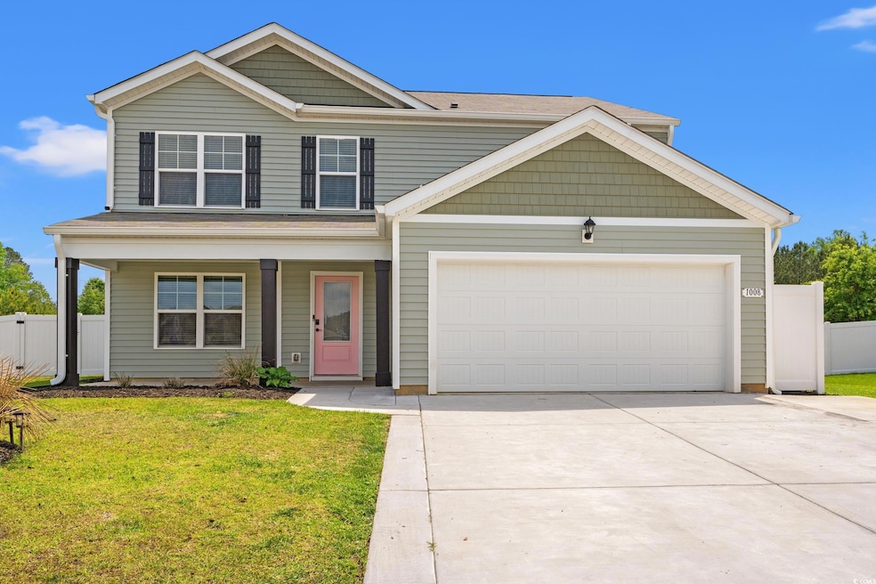 Traditional home with driveway, a porch, a front y
