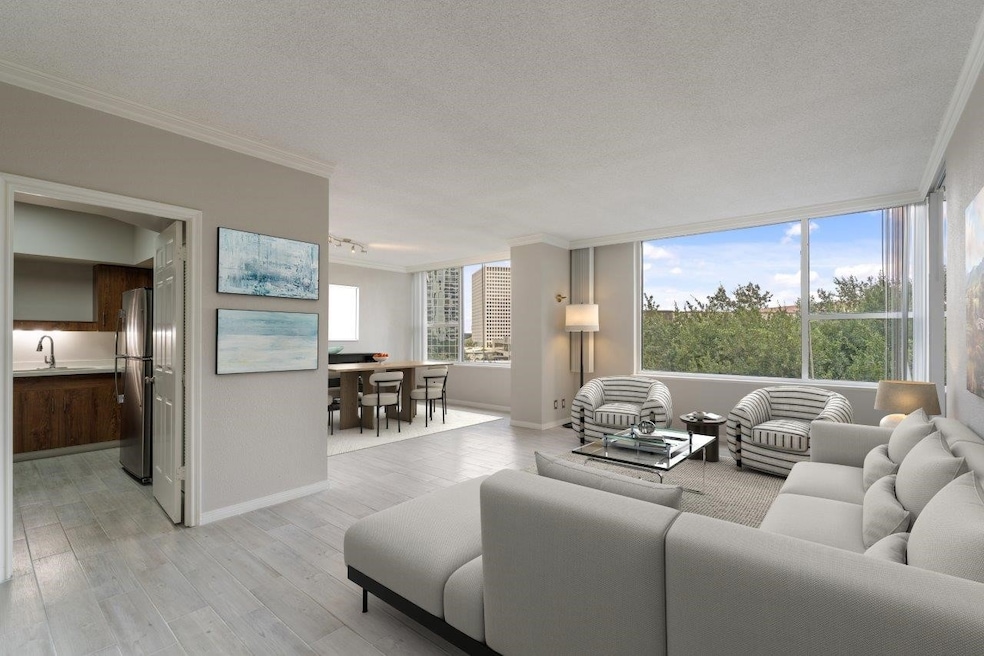 Treetop views with light filled spaces. Virtually staged.