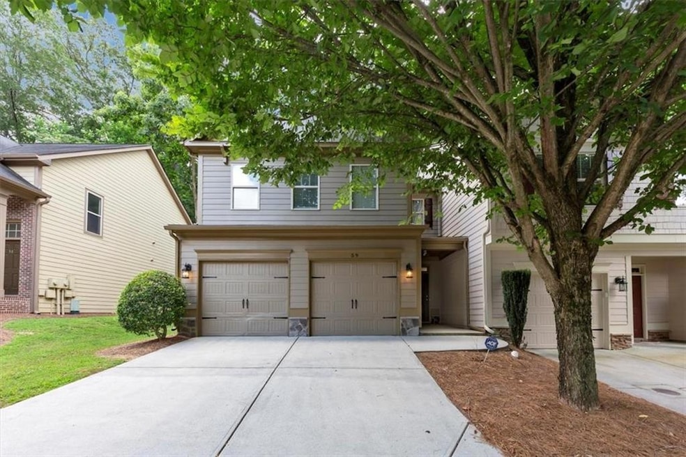 Traditional-style home with concrete driveway, an attached garage, and stone siding