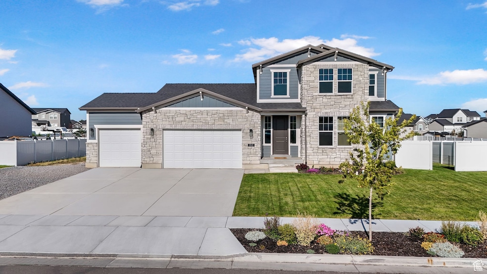 Craftsman house with stone siding, an attached 3 car garage, and concrete driveway
