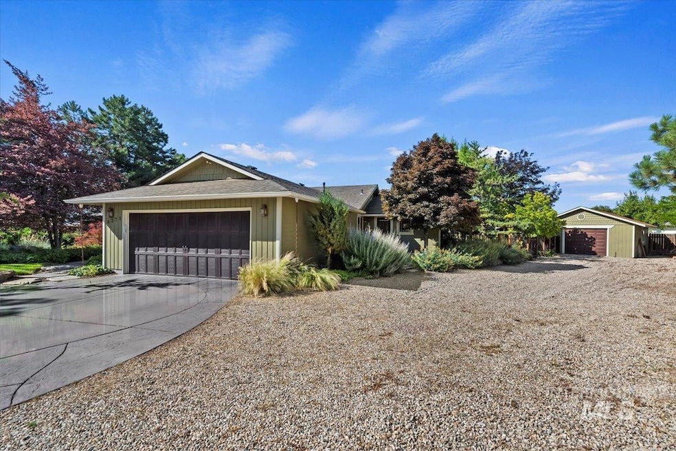 View of front of home featuring a garage, driveway, roof with shingles, and board and batten siding