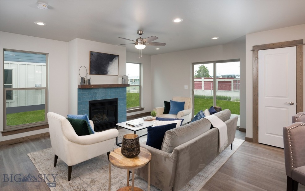 Living room with gas fireplace and oversized windo