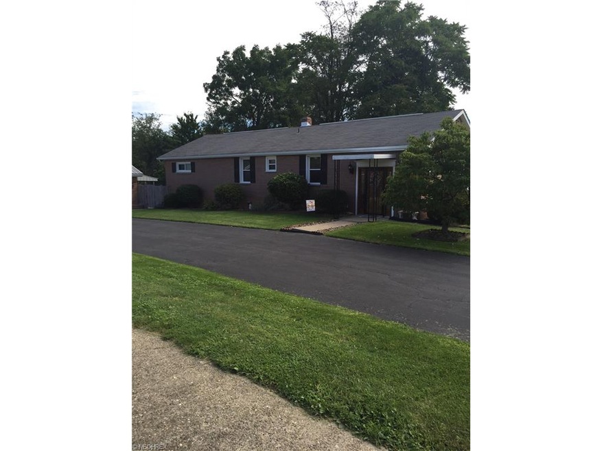 Brick ranch paved drive..