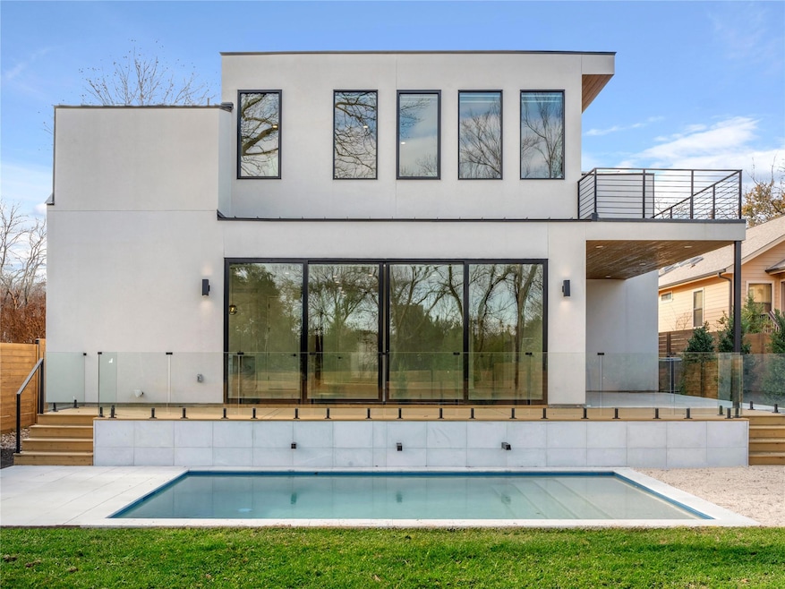 Rear view of house featuring a patio area and stucco siding