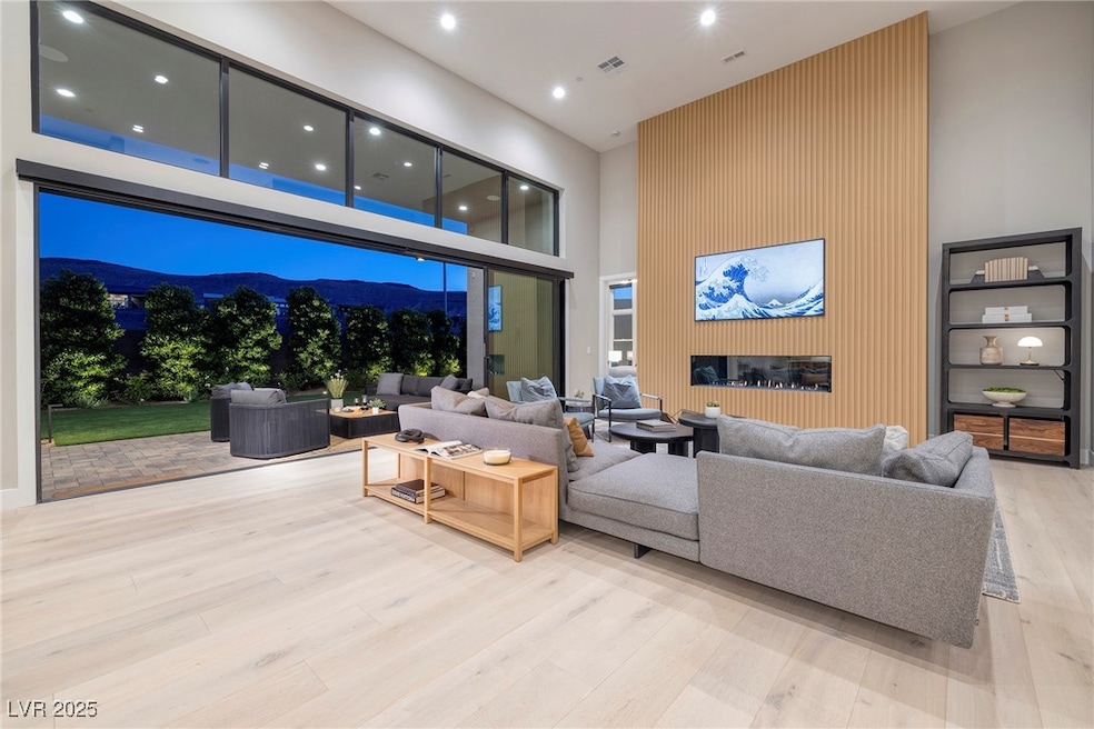 Living area featuring a high ceiling, recessed lig
