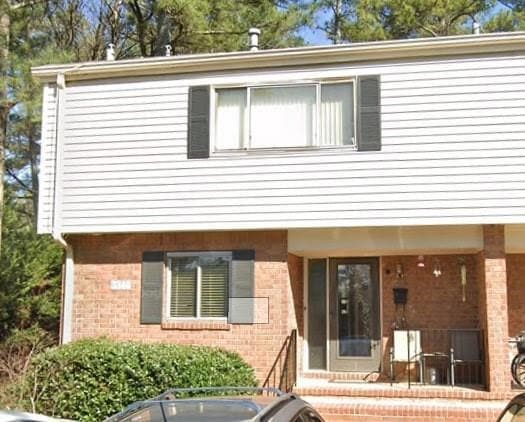 View of front of house featuring brick siding