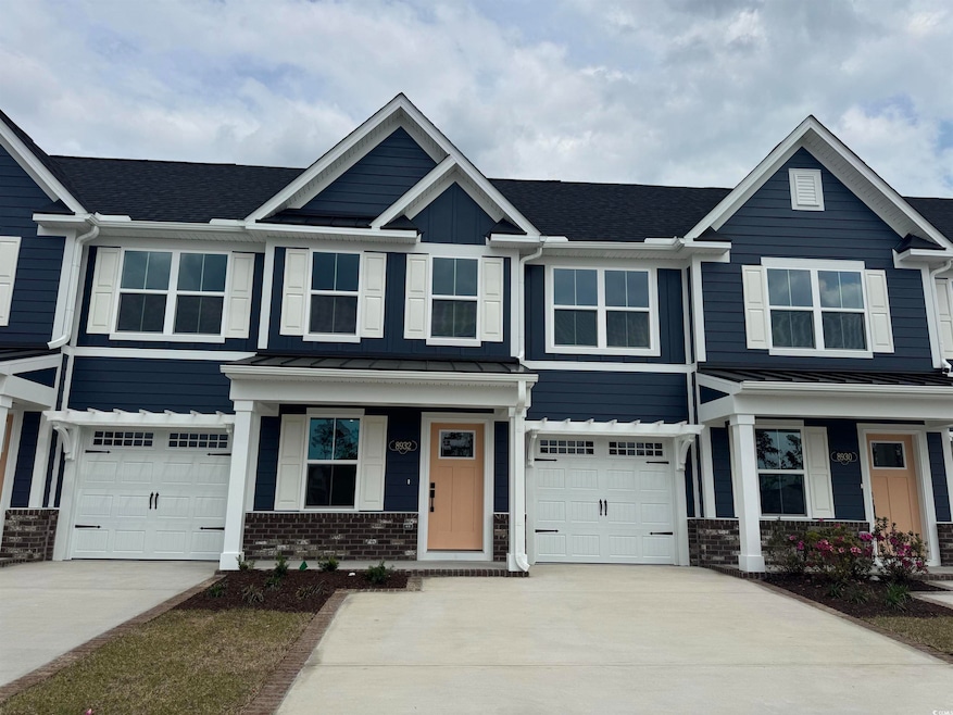 Craftsman-style home with brick siding, a garage, 